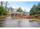 Backyard of a single-Gathering home featuring a long driveway and expansive wooden deck, covered from rain at 2044 Wilandrew Dr, Decatur, GA 30033