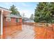 Large wooden deck with a brick exterior provides a perfect space for outdoor entertaining with an eye-pleasing yard at 2044 Wilandrew Dr, Decatur, GA 30033