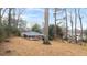 Expansive backyard with mature trees surrounding the property and neighboring houses at 2044 Wilandrew Dr, Decatur, GA 30033