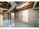 Unfinished basement with exposed ceiling, ductwork, and gray painted walls at 2044 Wilandrew Dr, Decatur, GA 30033