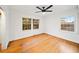 Cozy bedroom featuring hardwood floors, two windows, and a ceiling fan at 2044 Wilandrew Dr, Decatur, GA 30033