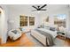 Bedroom with hardwood floors, ceiling fan, area rug, and two windows at 2044 Wilandrew Dr, Decatur, GA 30033