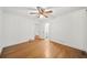 Cozy bedroom features beautiful wood floors, paneled walls, and ceiling fan at 2044 Wilandrew Dr, Decatur, GA 30033