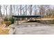Carport at the back of the house with a solid roof and stone wall at 2044 Wilandrew Dr, Decatur, GA 30033