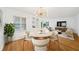 Dining room featuring hardwood floors, modern chandelier and built-in shelves at 2044 Wilandrew Dr, Decatur, GA 30033