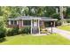 Charming single-story brick home with manicured lawn, covered carport, and inviting entrance at 2044 Wilandrew Dr, Decatur, GA 30033