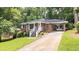 Charming brick home featuring a covered carport, well-maintained landscaping, and inviting front porch at 2044 Wilandrew Dr, Decatur, GA 30033