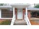 Close-up of the front door with decorative railings and a covered entrance at 2044 Wilandrew Dr, Decatur, GA 30033