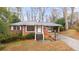Charming brick home with a covered carport and mature landscaping at 2044 Wilandrew Dr, Decatur, GA 30033