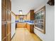 Traditional kitchen featuring wood cabinets, blue backsplash, and hardwood floors at 2044 Wilandrew Dr, Decatur, GA 30033
