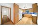 Traditional kitchen with wood cabinets, blue backsplash, and hardwood floors at 2044 Wilandrew Dr, Decatur, GA 30033