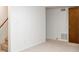 Neutral living room featuring carpeted floors, stairs, and a door with white walls at 2044 Wilandrew Dr, Decatur, GA 30033
