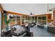 Bright sun room featuring hardwood floors, ceiling fan and large windows at 2044 Wilandrew Dr, Decatur, GA 30033