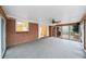 Covered sunroom with brick wall, carpeted floor, and access to the backyard at 2044 Wilandrew Dr, Decatur, GA 30033