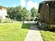 Spacious backyard featuring lush greenery, a walkway, and partial fencing enhances outdoor appeal at 1244 Hickory Wood Ne Dr, Woodstock, GA 30188