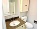 Well-lit bathroom features a vanity with granite countertop and wooden cabinet with storage at 1244 Hickory Wood Ne Dr, Woodstock, GA 30188