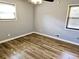 Bedroom with wood flooring, ceiling fan with light fixture and window at 1244 Hickory Wood Ne Dr, Woodstock, GA 30188