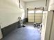 Clean garage featuring painted floors, overhead storage, and bright lighting; great for storage and projects at 1244 Hickory Wood Ne Dr, Woodstock, GA 30188