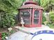 Enclosed backyard gazebo with screen windows and a decorative fountain on a concrete patio near the swimming pool at 1244 Hickory Wood Ne Dr, Woodstock, GA 30188