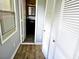 Hallway to bathroom with wood flooring, closet with folding doors and window with blind at 1244 Hickory Wood Ne Dr, Woodstock, GA 30188