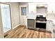Well-lit kitchen featuring stainless steel appliances, new cabinets and a door to the backyard at 1244 Hickory Wood Ne Dr, Woodstock, GA 30188