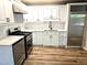 Modern kitchen showcasing white cabinets, stainless steel appliances, and stylish backsplash at 1244 Hickory Wood Ne Dr, Woodstock, GA 30188