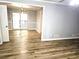 Open-concept living space with neutral walls, updated floors and a view of the dining room at 1244 Hickory Wood Ne Dr, Woodstock, GA 30188