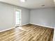 Living room featuring wood flooring, neutral wall color and glass door to patio at 1244 Hickory Wood Ne Dr, Woodstock, GA 30188