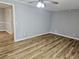 Bright living room featuring modern flooring, neutral walls and ceiling fan at 1244 Hickory Wood Ne Dr, Woodstock, GA 30188