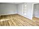 Living room featuring wood flooring, neutral wall color and built-in bookshelf at 1244 Hickory Wood Ne Dr, Woodstock, GA 30188