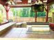 Gazebo featuring an outdoor kitchen with a stainless steel grill, countertop space, and ceiling fans and a mounted TV at 1244 Hickory Wood Ne Dr, Woodstock, GA 30188