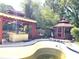 Backyard pool area featuring a gazebo with an outdoor kitchen and another closed gazebo for relaxing by the pool at 1244 Hickory Wood Ne Dr, Woodstock, GA 30188