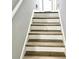 View of the staircase with new flooring and freshly painted walls at 1244 Hickory Wood Ne Dr, Woodstock, GA 30188