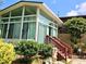 Exterior shot of a large sunroom with surrounding greenery at 1244 Hickory Wood Ne Dr, Woodstock, GA 30188