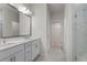 Hall bathroom with double sink vanity and marble-tiled walk-in shower at 15 Parkside Vw, Cartersville, GA 30121