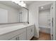 Well-lit bathroom features a large mirror, white cabinets, and a separate shower/tub area at 15 Parkside Vw, Cartersville, GA 30121