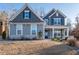 Beautiful two-story home with a covered front porch, stone accents, and well-manicured lawn at 15 Parkside Vw, Cartersville, GA 30121