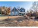 Inviting two-story home with a covered front porch and a spacious front yard with mature trees at 15 Parkside Vw, Cartersville, GA 30121