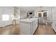 Bright open kitchen features an island with bar seating, stainless steel appliances, and hardwood floors at 15 Parkside Vw, Cartersville, GA 30121