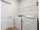 Laundry room area featuring a washer, dryer, and storage shelves at 15 Parkside Vw, Cartersville, GA 30121