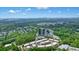 A birds eye view of upscale townhomes surrounded by lush landscaping with a commercial business in the background at 1598 Aldworth Se Pl, Marietta, GA 30067