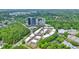 Aerial view of townhome community surrounded by lush greenery and a commercial center at 1598 Aldworth Se Pl, Marietta, GA 30067