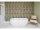 Luxurious bathroom featuring a freestanding tub and designer wallpaper at 1598 Aldworth Se Pl, Marietta, GA 30067