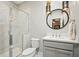 Modern bathroom featuring a walk-in shower with marble-style tile, a vessel sink, and decorative lighting at 1598 Aldworth Se Pl, Marietta, GA 30067