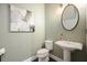 Charming powder room features a pedestal sink and decorative wall art at 1598 Aldworth Se Pl, Marietta, GA 30067