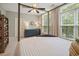 Bedroom featuring a four-poster bed, dresser, and natural light at 1598 Aldworth Se Pl, Marietta, GA 30067