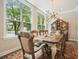 Dining room boasts large windows, modern lighting, and a rustic wooden table at 1598 Aldworth Se Pl, Marietta, GA 30067