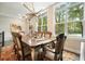 Dining room features a rustic wooden table, stylish chairs, and large windows at 1598 Aldworth Se Pl, Marietta, GA 30067