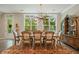Bright dining room featuring a large table, decorative chandelier, and expansive windows at 1598 Aldworth Se Pl, Marietta, GA 30067