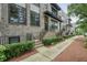 Townhouse showcases a sidewalk and landscaped bushes leading to the front door at 1598 Aldworth Se Pl, Marietta, GA 30067